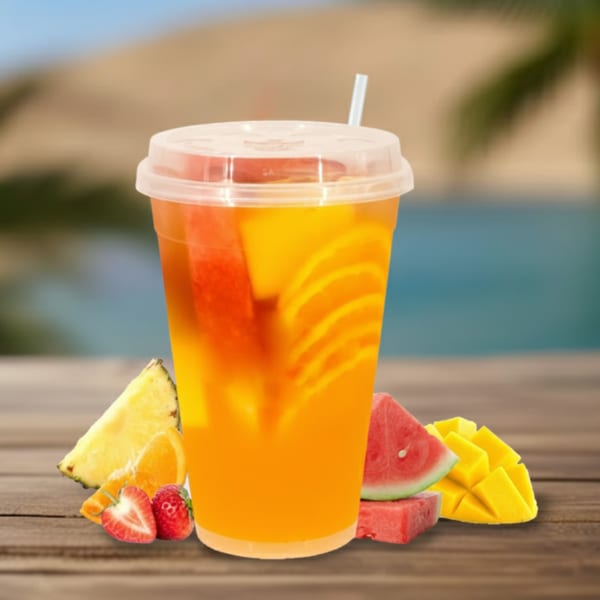 Tropical fruit drink with watermelon, orange, and pineapple slices on a wooden table by a pool.